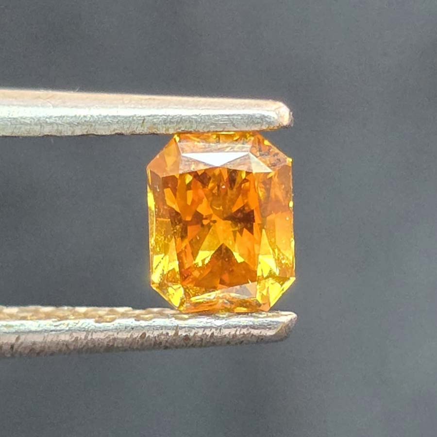 0.47 carat Emerald Brownish orange