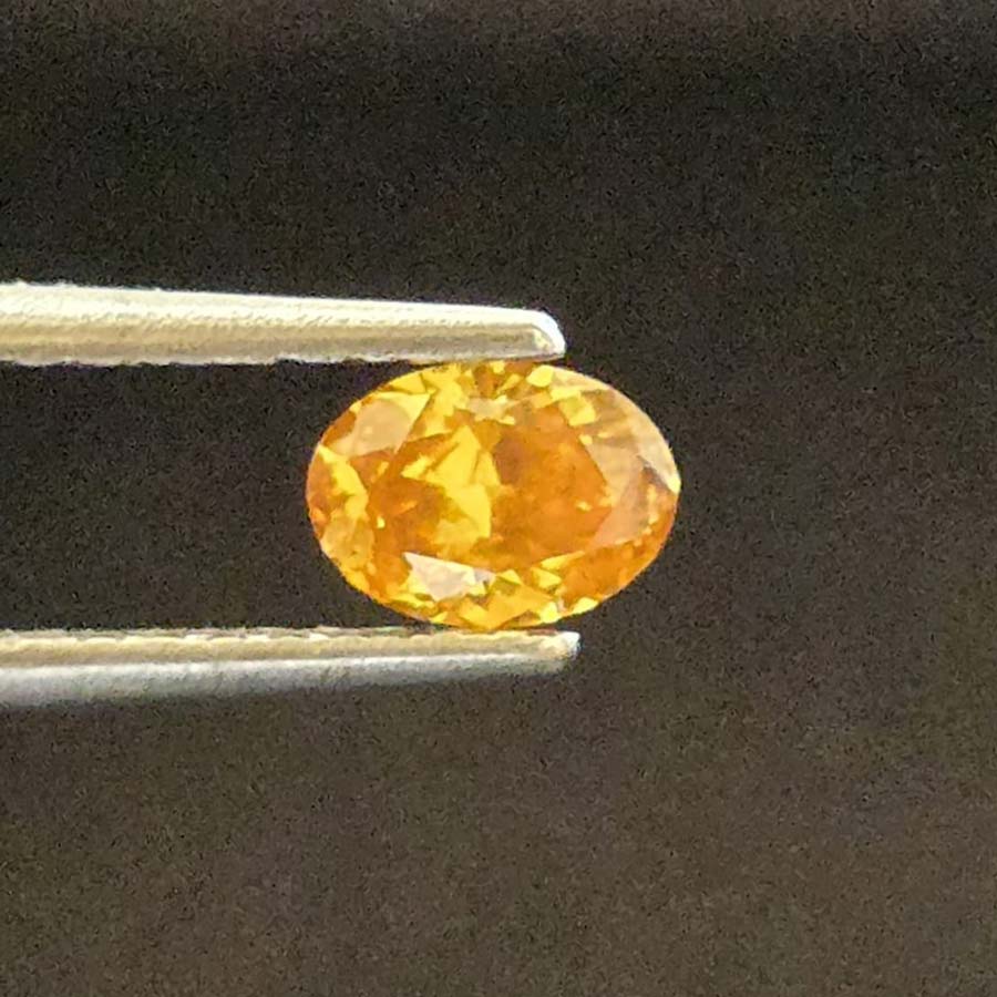 0.53 carat oval fancy dark orange yellow