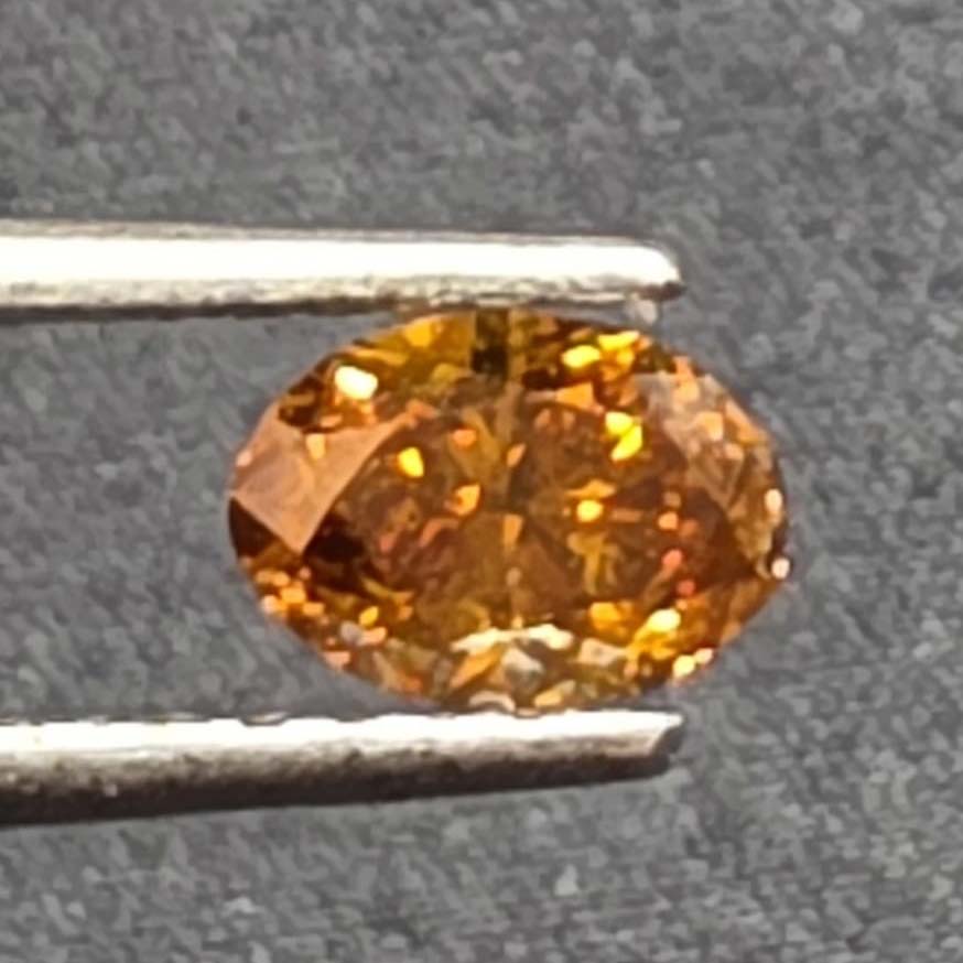 0.77 carat oval vivid fancy yellow orange